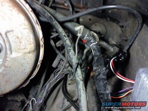 Engine wiring harness with black tape and colorful wires