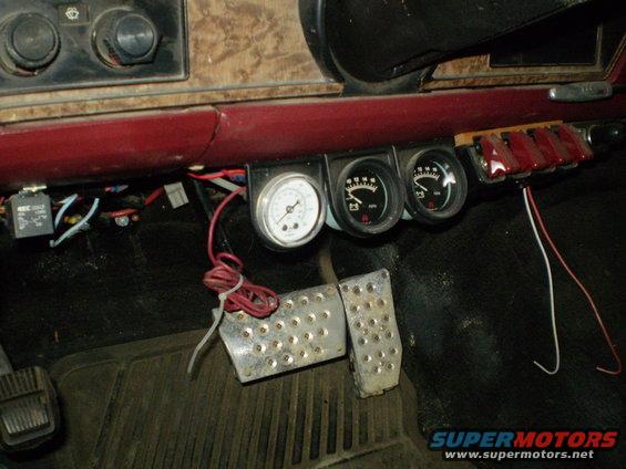Interior dashboard with three gauges and aftermarket pedals