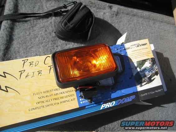 Pro Comp off-road light with wiring kit on a box