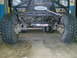 1984 Ford Bronco II - The front axle and suspension of a heavily modified off-road vehicle are shown in detail.