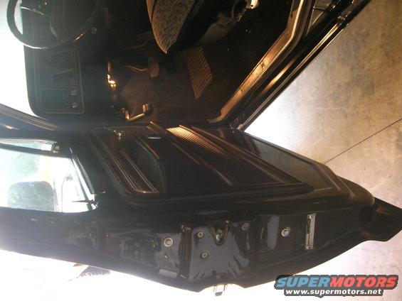 Interior view of a black truck door panel and dashboard