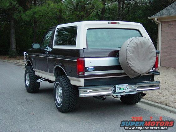 1992 Ford Bronco rear view, dark brown and white, with spare tire mounted on the back