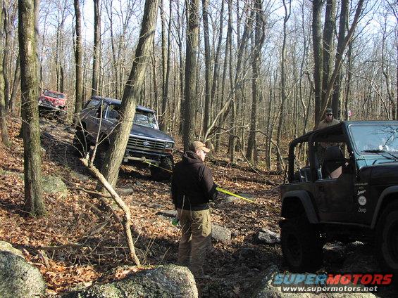 Dark blue Ford Bronco on rocky trail, front view