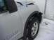 2008 Nissan Titan - Front quarter panel and wheel of a silver 2008 Nissan Titan in the snow.