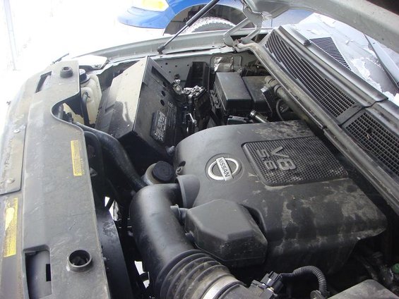 Engine bay of a 2008 Nissan Titan, showing the V8 engine cover with Nissan logo and 5.6L designation