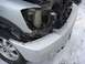 2008 Nissan Titan - Damaged front end of a white pickup truck with snow on the ground.