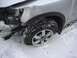 2008 Nissan Titan - A silver SUV with a damaged front fender and flat tire sits in the snow, showing a 'V8' badge.
