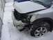 2008 Nissan Titan - A silver pickup truck sustained significant damage to its front end, shown here in a snowy environment with another vehicle partially visib…