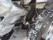 2008 Nissan Titan - The front passenger side of a vehicle shows significant damage to the fender and suspension system, with snow on the tire.