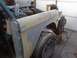 1972 Ford Bronco - A 1972 Ford Bronco fender is being prepped for paint, revealing its underlying structure and a tire.