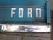 1972 Ford Bronco - Close-up of a Ford tailgate with visible lettering and metal repair.