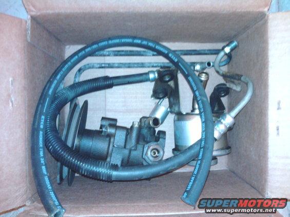 Power steering pump and hoses in a cardboard box