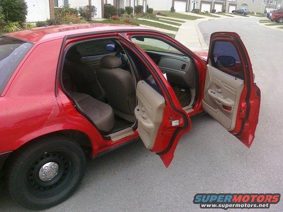 Red 2002 Ford Crown Victoria sedan, side view with all doors open
