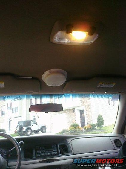 2002 Ford Crown Victoria interior, dashboard, steering wheel, rearview mirror, and a white Jeep visible through the windshield