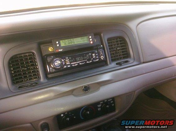 2002 Ford Crown Victoria interior showing dashboard, aftermarket stereo, and air vents