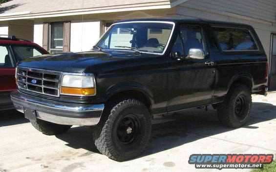 Black 1992 Ford Bronco parked on concrete, front 3/4 view, showing chrome bumper and grille