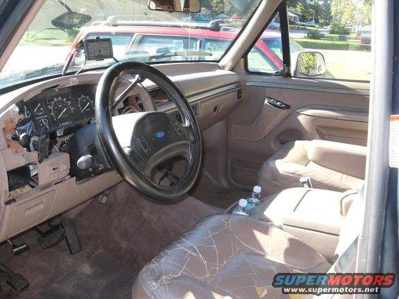 1992 Ford Bronco interior with cracked tan leather seats and dashboard gauges