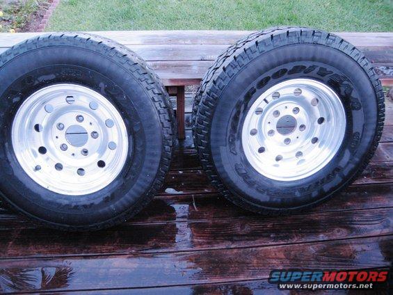 Two Goodyear Wrangler tires on polished aluminum wheels