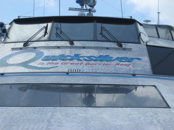 Front of a boat with "Quicksilver is the Great Barrier Reef" text