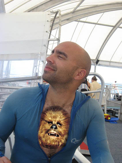Bald man in blue zip-up shirt with Chewbacca's face photoshopped onto his chest