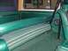 1978 Ford Bronco - Interior view of a vintage SUV, highlighting the green striped rear bench seat and matching door panels.