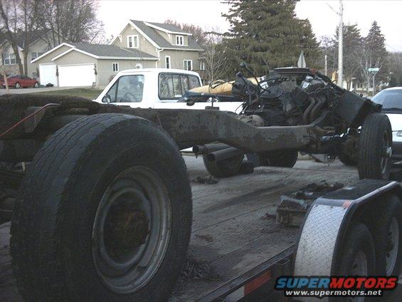 Truck cab-and-chassis on a trailer in a residential street
