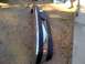 1989 Ford Bronco - A chrome bumper with a license plate bracket is shown on the ground.