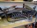 1989 Ford Bronco - A collection of automotive suspension components, including shocks and springs, are stored on a shelf.