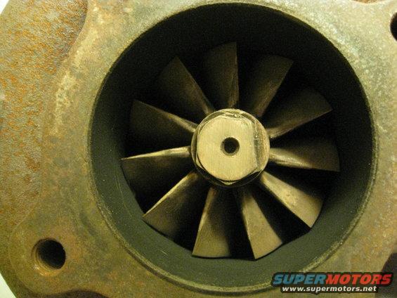 Turbocharger compressor wheel with visible blades and center nut