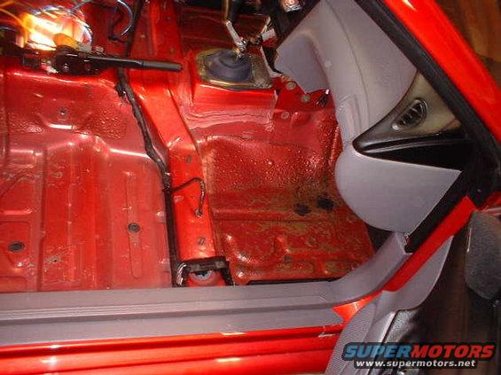1994 Ford Mustang interior showing red floor pan and center console area