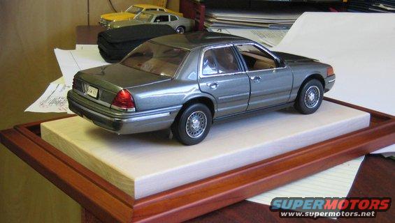1/18th scale model Ford Crown Victoria on display base, with two other model cars in background