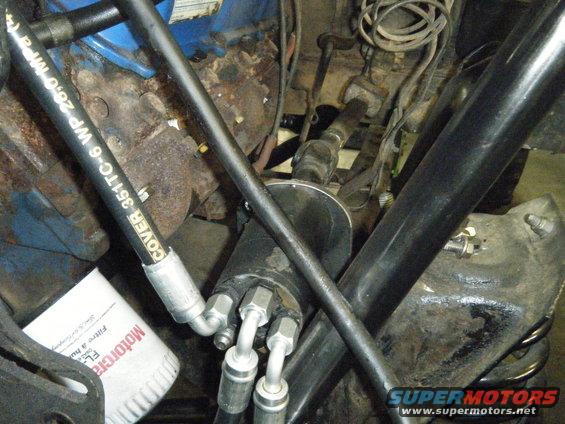 Engine bay with hydraulic lines, oil filter, and hoses