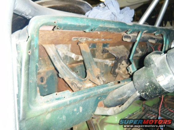 Green interior dashboard with rust and exposed components. Steering column visible