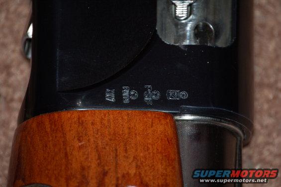Shotgun receiver with proof marks and wood stock