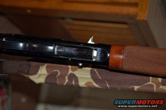 Shotgun receiver with wood stock and visible serial number