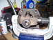 1991 Ford Bronco - Universal joint assembly being worked on in a vise, with tools and fluids nearby.