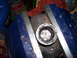 1991 Ford Bronco - A drive shaft component is secured in a vise, likely for a repair or rebuild.