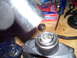 1991 Ford Bronco - A drive shaft part is shown on a workbench next to a Duralast box and tools, suggesting a repair or rebuild.