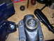 1991 Ford Bronco - Close-up of a brake caliper part being worked on, secured in a vise with tools present.