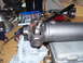 1991 Ford Bronco - A close-up view of a vehicle's driveshaft universal joint, surrounded by various tools and a spray can.