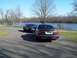 1999 Mercury Grand Marquis - Two Mercury Grand Marquis sedans are parked near a body of water on a clear day.