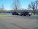 1999 Mercury Grand Marquis - Two Ford Crown Victoria police interceptors are parked near a body of water on a clear day.