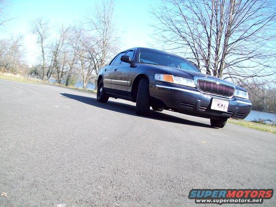 Dark sedan, 3q front view. License plate reads MCM 6