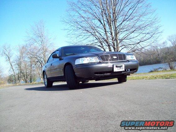Dark sedan, 3/4 front view. License plate reads CUN 64