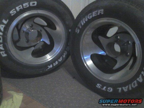 Two aftermarket wheels with white letter tires, one labeled Radial SR50, the other Stinger Radial GTS