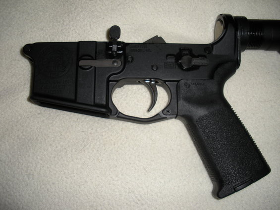 Close-up of an AR-15 lower receiver with trigger and pistol grip