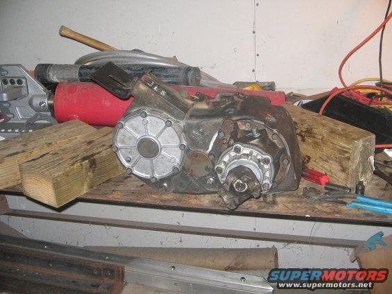 Transfer case with JLS marking on a workbench with tools and wood blocks