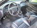 2001 Ford Mustang - The interior of a 2001 Ford Mustang features black leather seats and a manual transmission.
