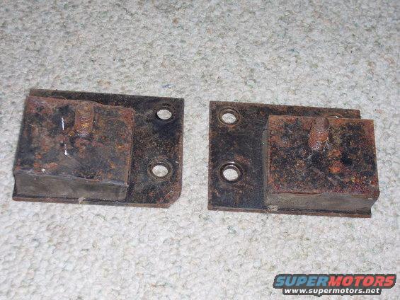 Pair of rusty engine mounts with bolts
