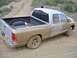 2005 Dodge 1500 - This pickup truck is heavily covered in mud after driving off-road.